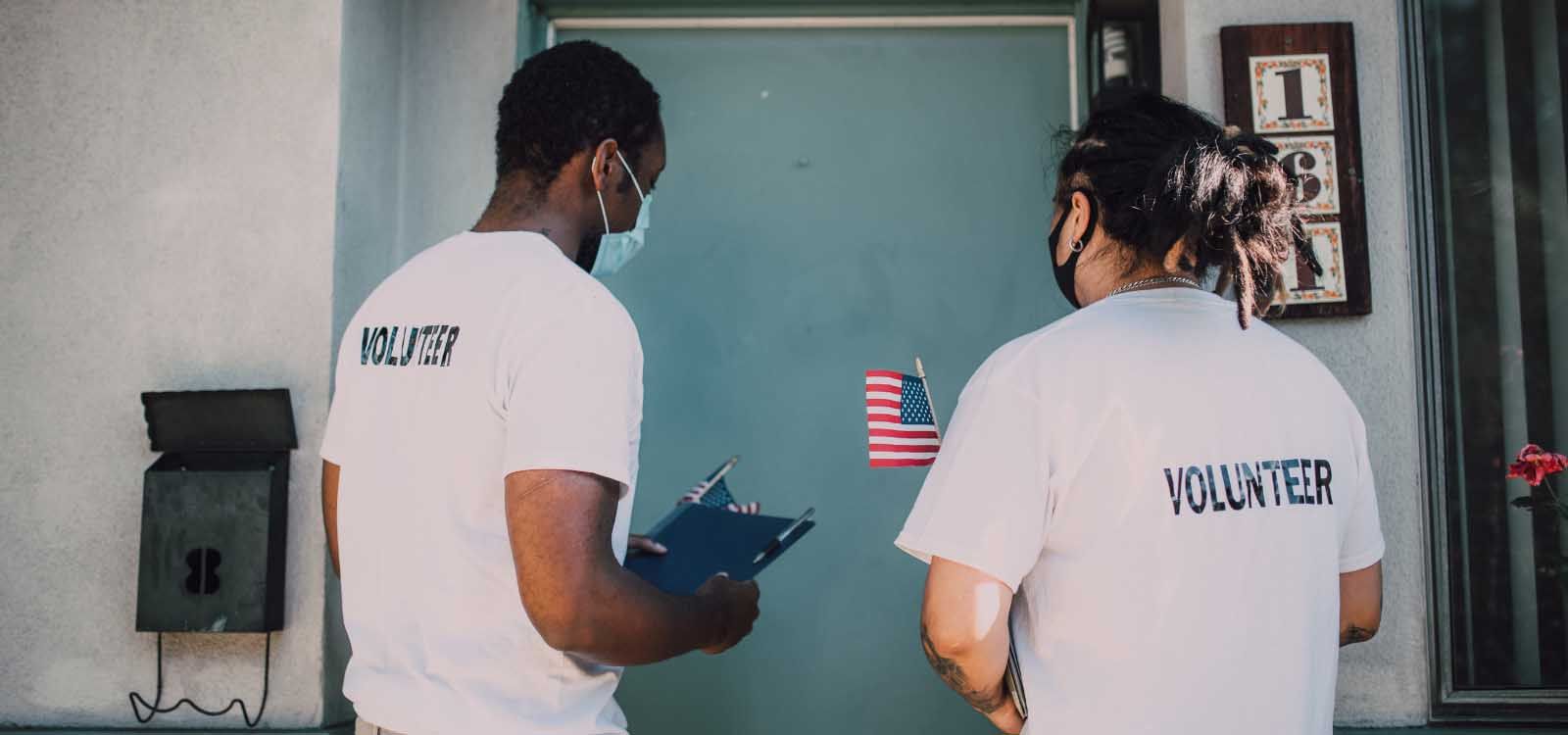 Two men in white shirts stand in front of a house, showcasing a casual and friendly demeanor.